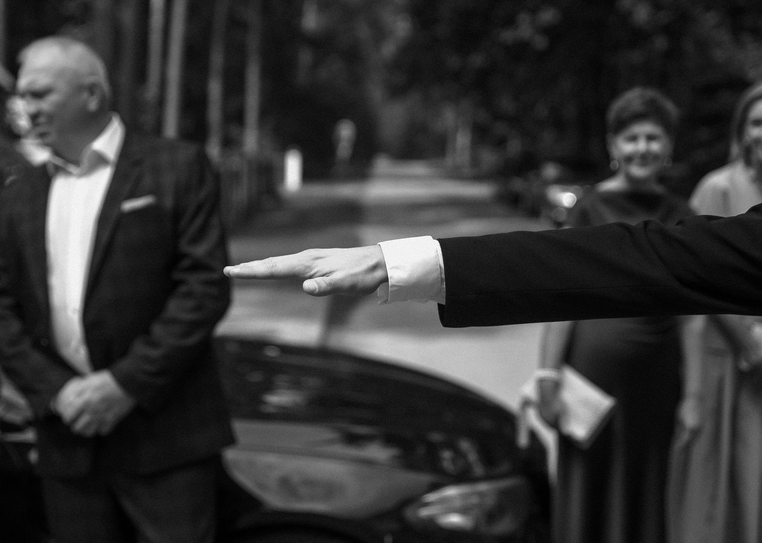 A wedding party poses playfully in a series of candid black and white photos.