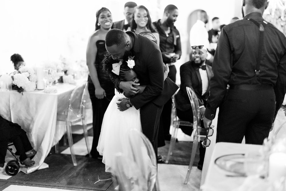 A series of black and white wedding photos showing guests dancing and celebrating at a reception party.