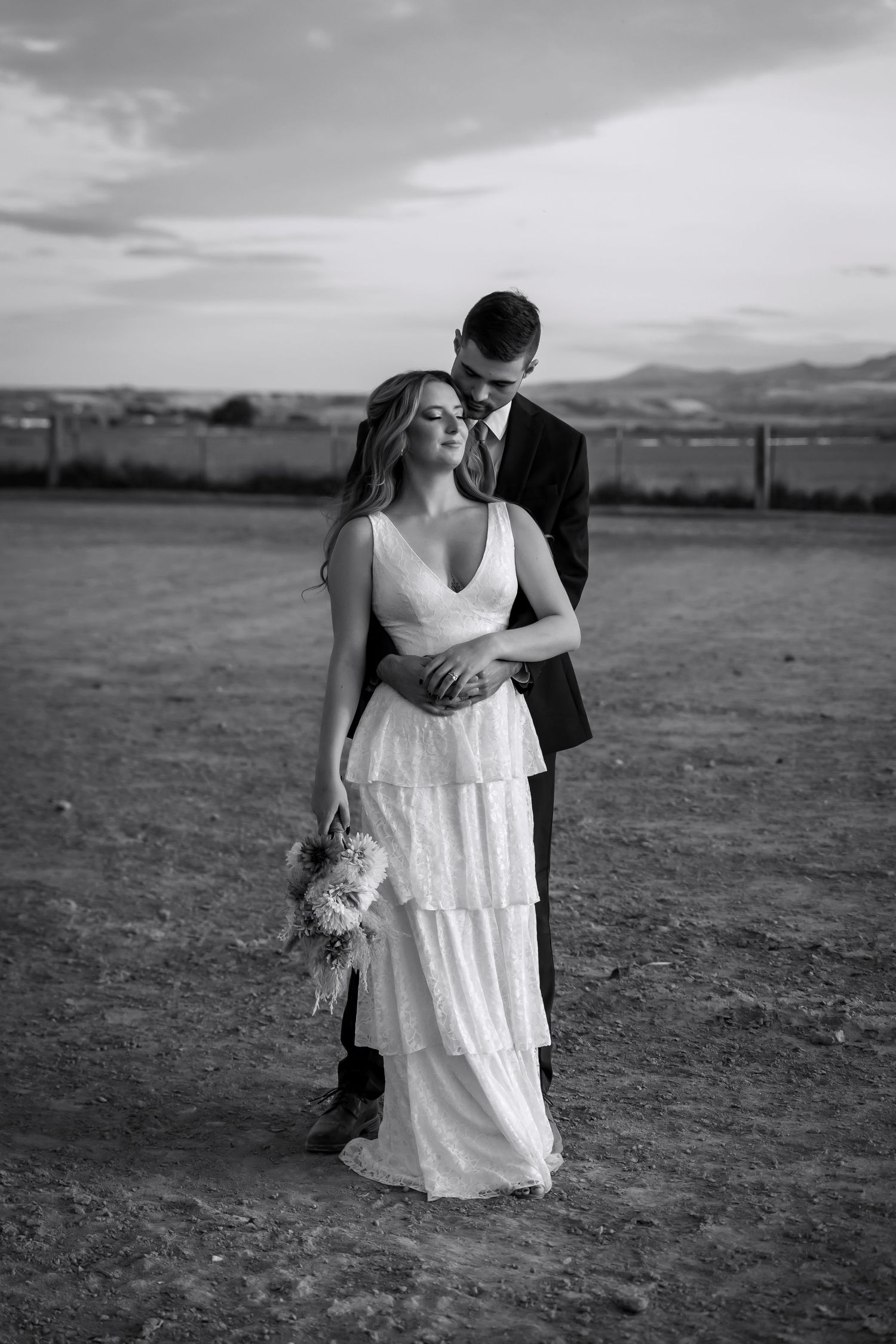 bride and groom photo with mountains on farm
