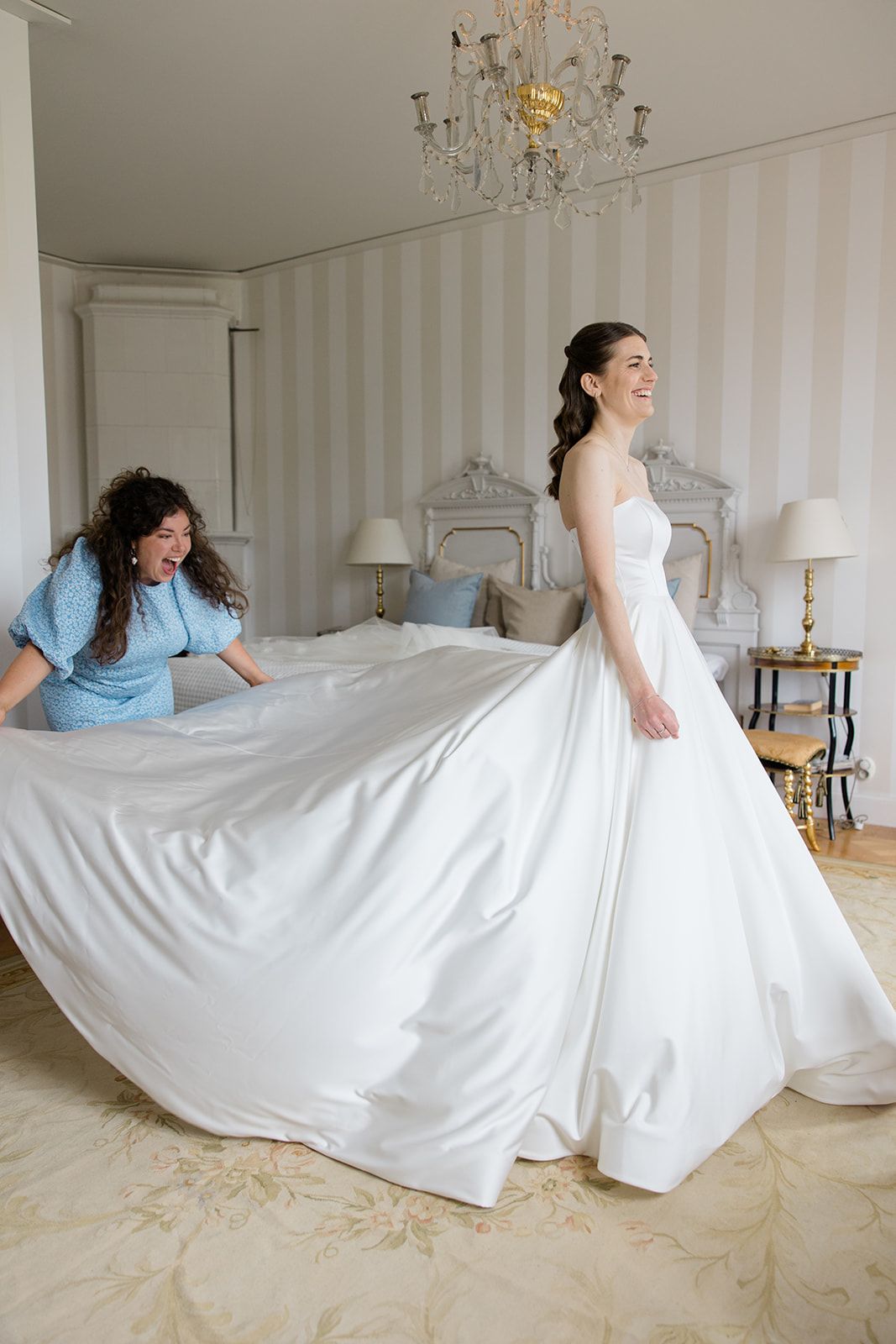 A sequence of four photos showing a bride in a white wedding dress lying down and rolling playfully on a beige carpet.