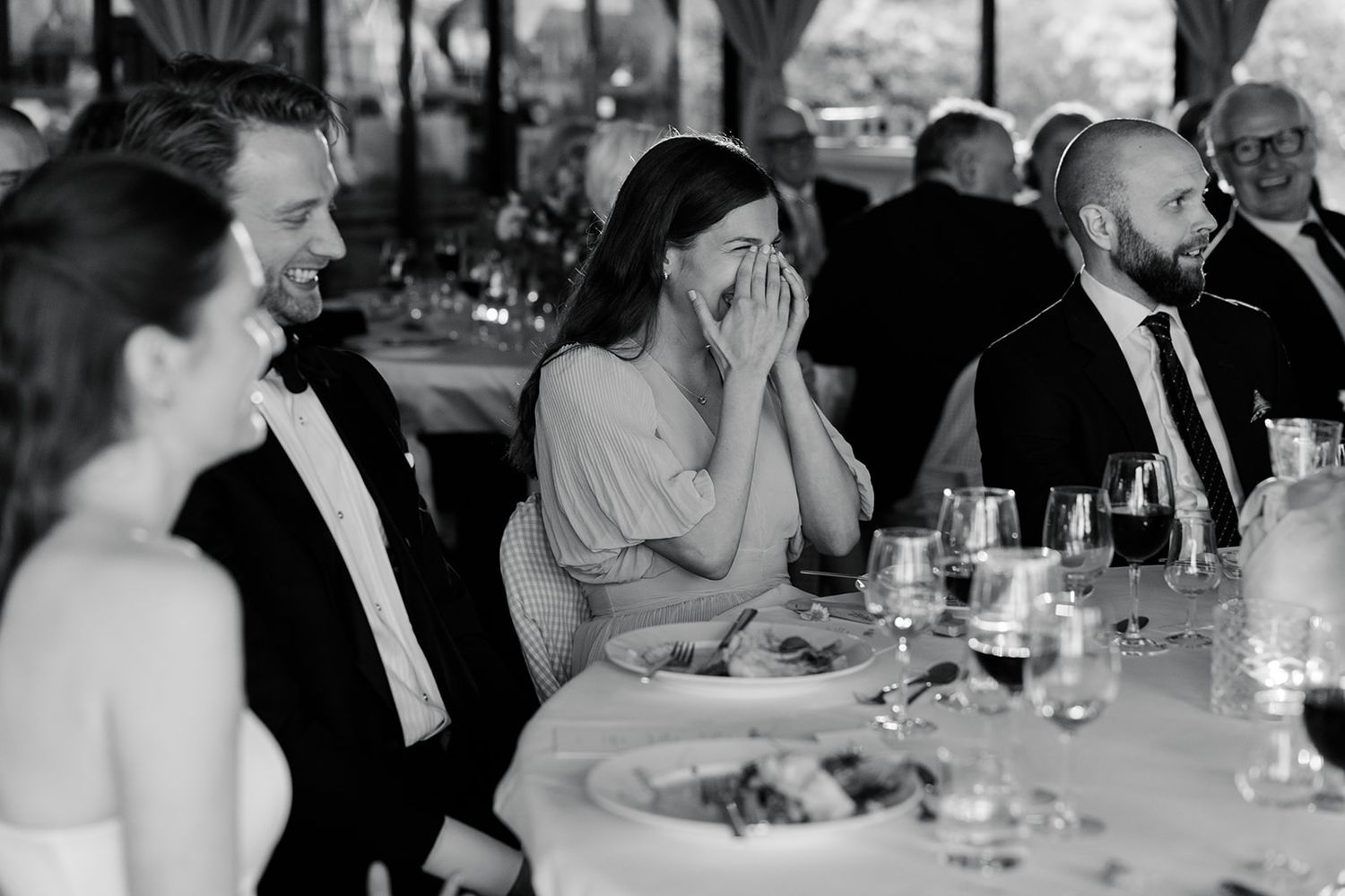 A black and white photo sequence shows candid expressions and laughter in a casual indoor setting.