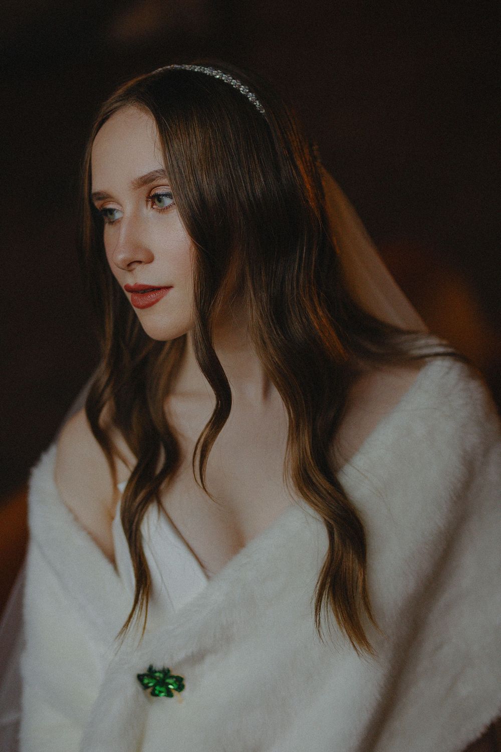 A series of moody portrait shots showing brown hair against a dark background with white clothing and red lipstick.
