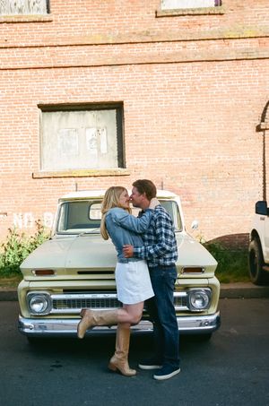 A sequence showing a couple interacting near a vintage car against a brick building.