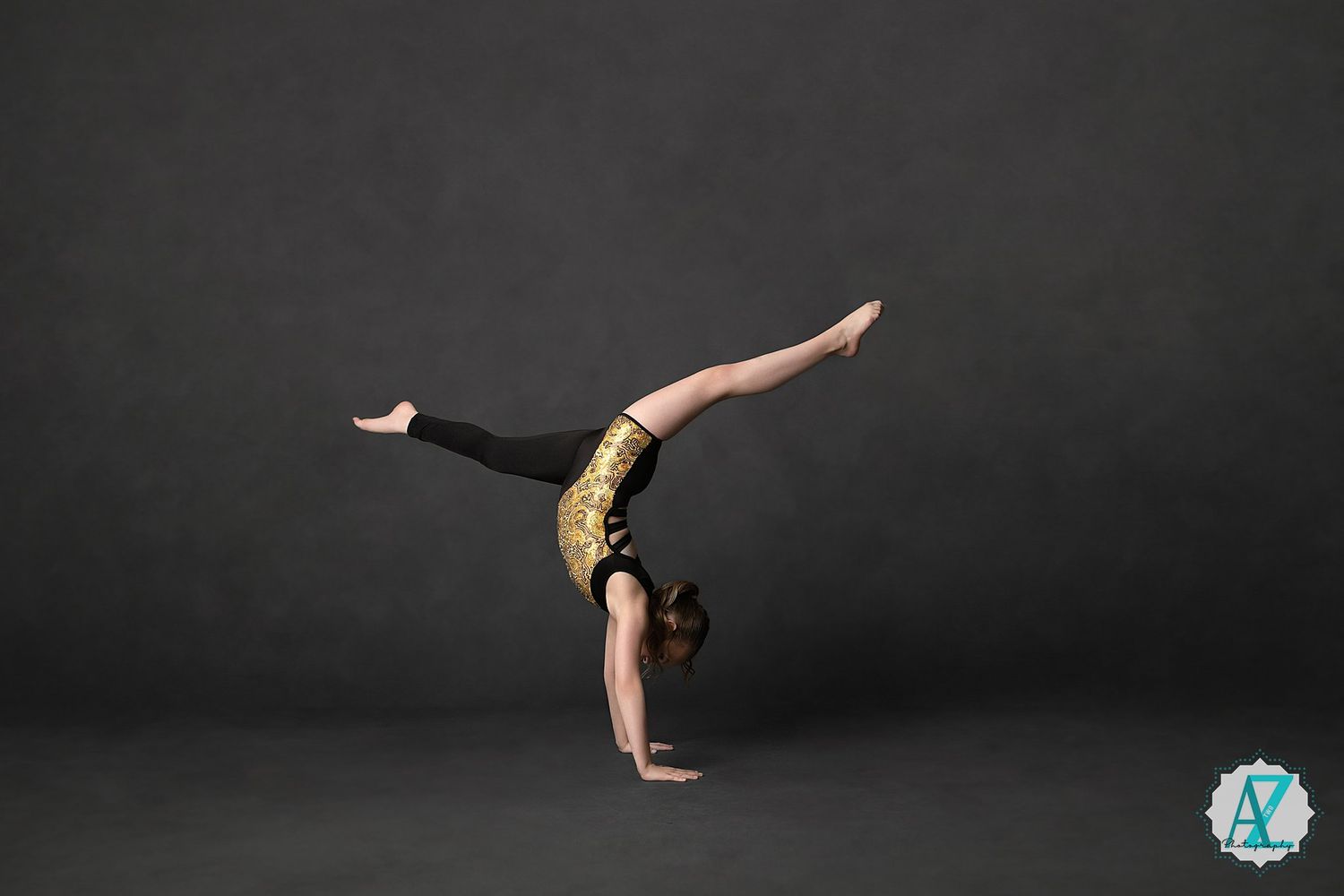 Graceful gymnast performing handstand sequence on dark background with artistic lighting and movement effects.
