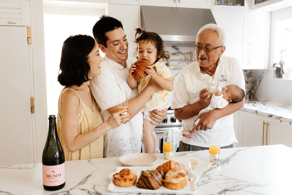 Family celebrates their new baby with breakfast and mimosas at their photography session - Bay Area in-home newborn session