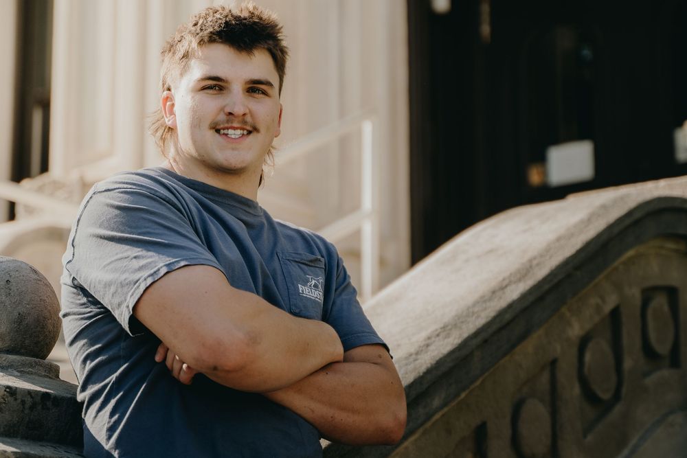 Casual outdoor senior portrait portrait showing person in grey t-shirt with arms crossed - Warsaw, Indiana
