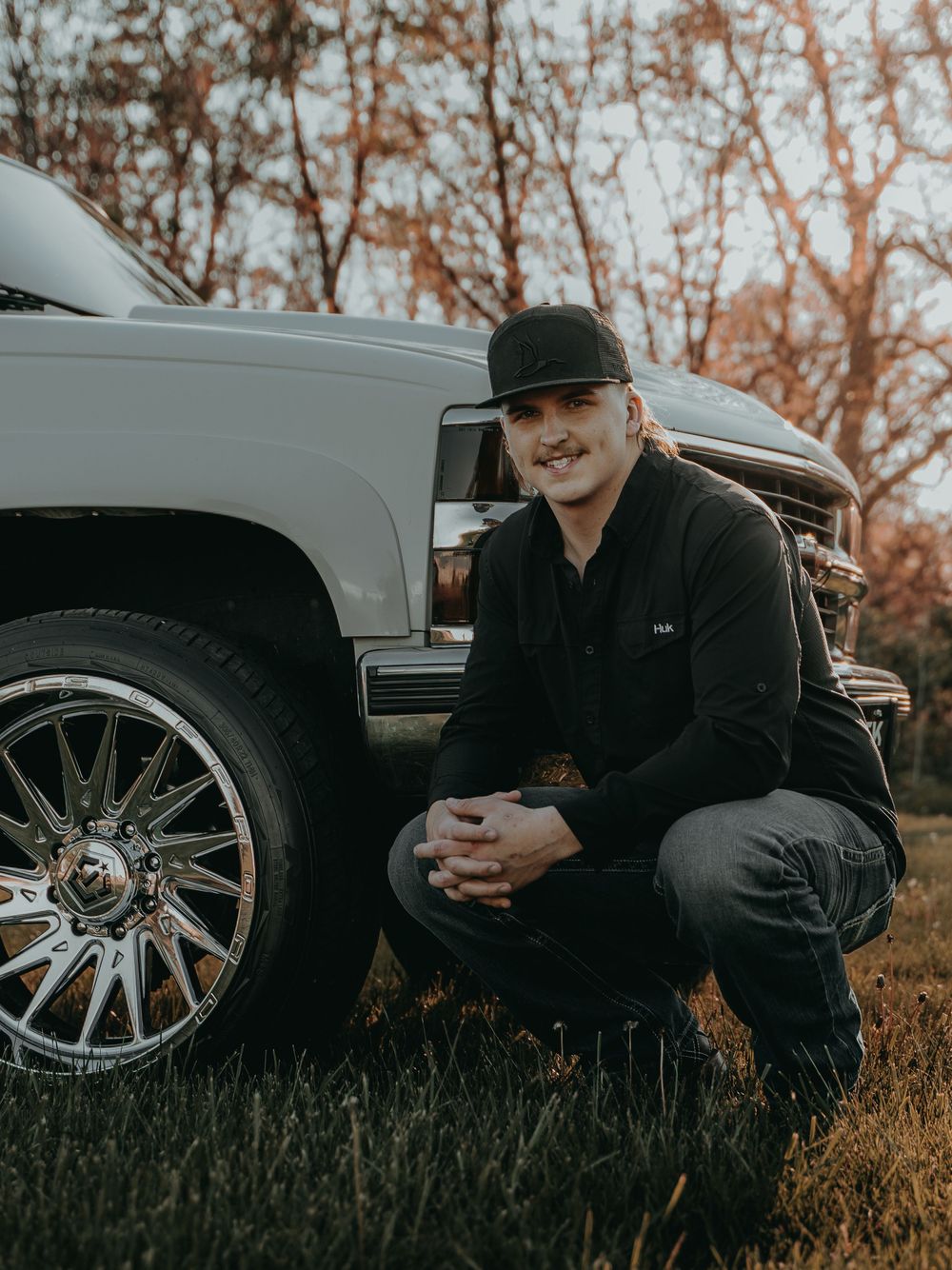 Senior Portrait with a custom truck with large chrome wheels photographed during autumn - Warsaw, Indiana