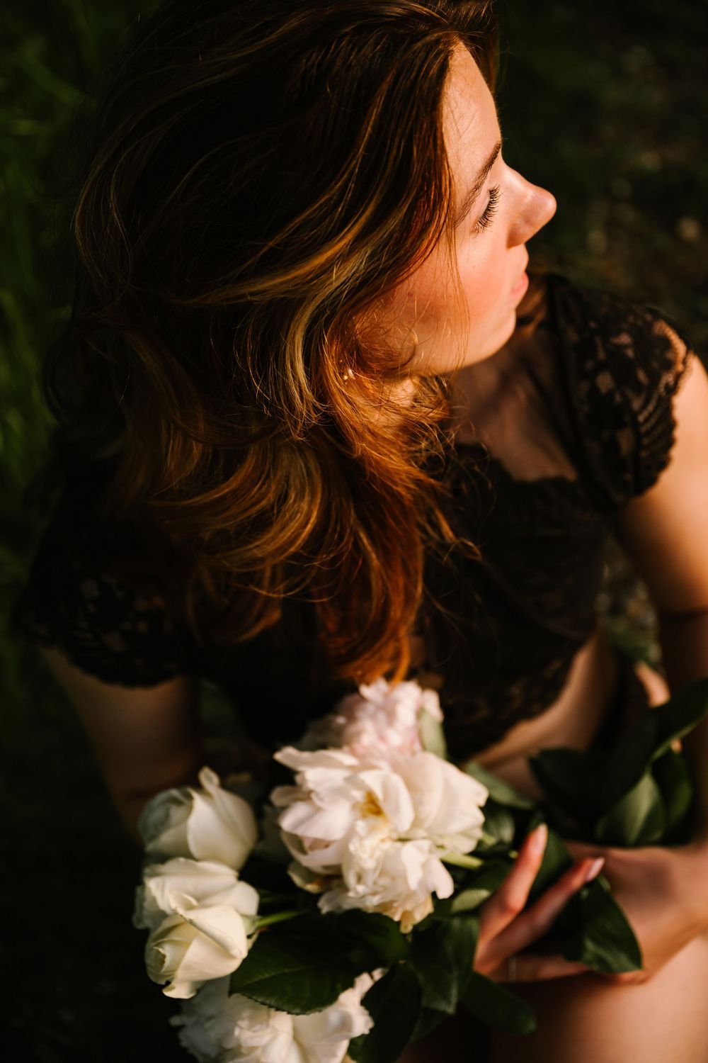 A series of moody portraits in dark lighting with white roses creating dramatic contrast and romantic atmosphere.