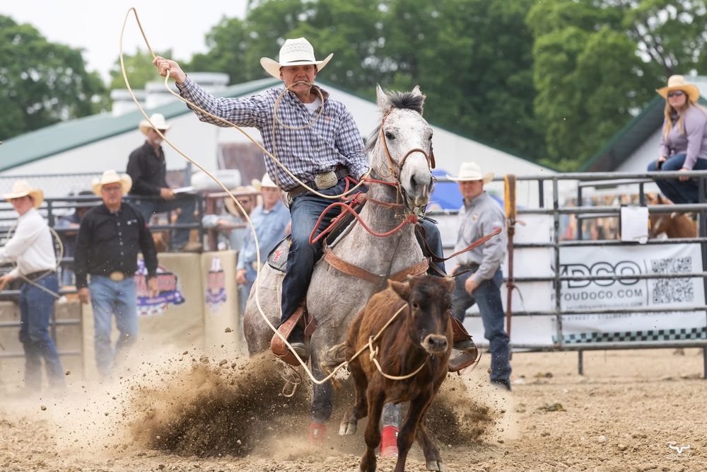 Rodeo rider on horseback kicking up dust in an arena during competition. Pro Rodeo PRCA Rodeo Photographer Dakota Cardenas