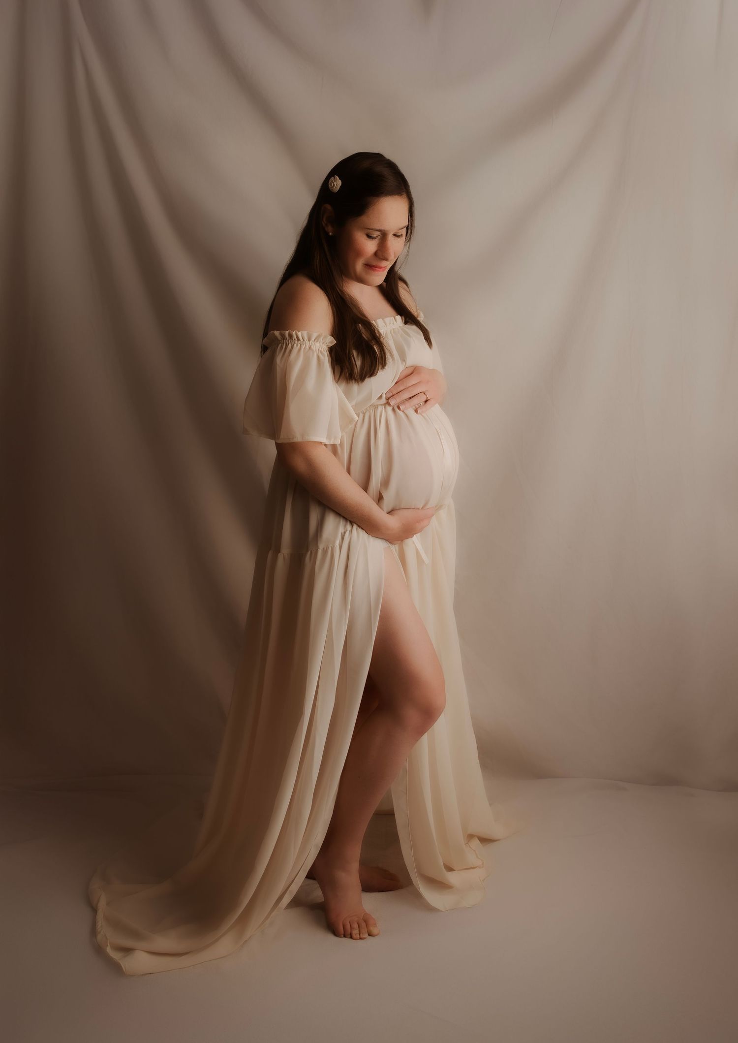 maternity pregnant woman holding belly in studio