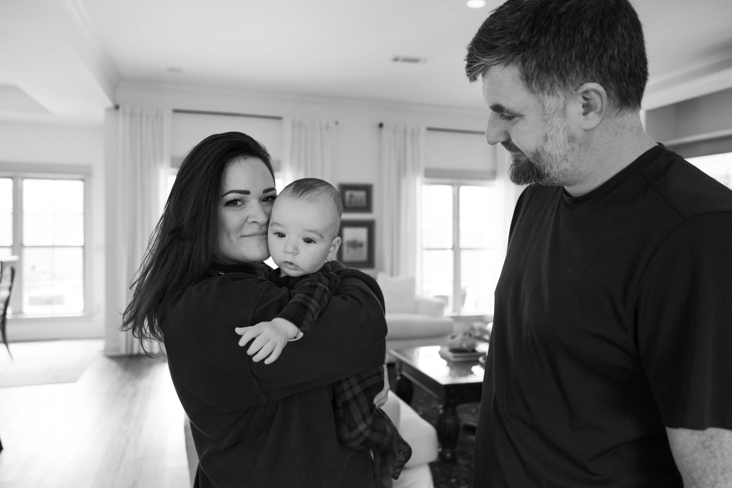 A family shares an intimate moment together in their bright, modern home interior.