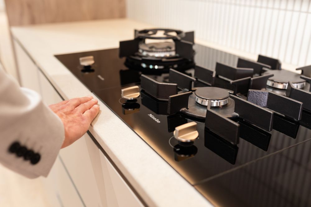 Close-up of black kitchen cabinet hardware and drawer mechanisms.