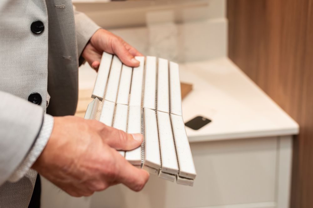 Hands holding white closet organizing rods or hanging hardware components.