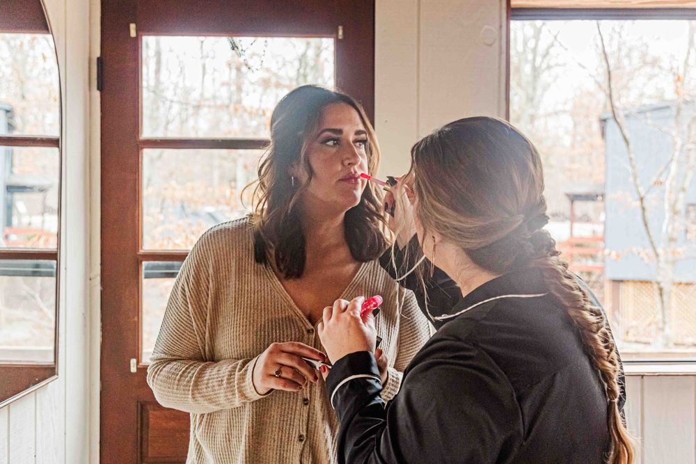 A makeup preparation scene in front of windows with natural light.