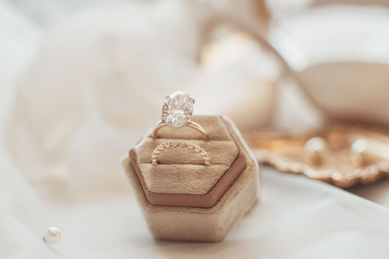 Close-up of an engagement ring in a hexagonal box with soft blurred background.