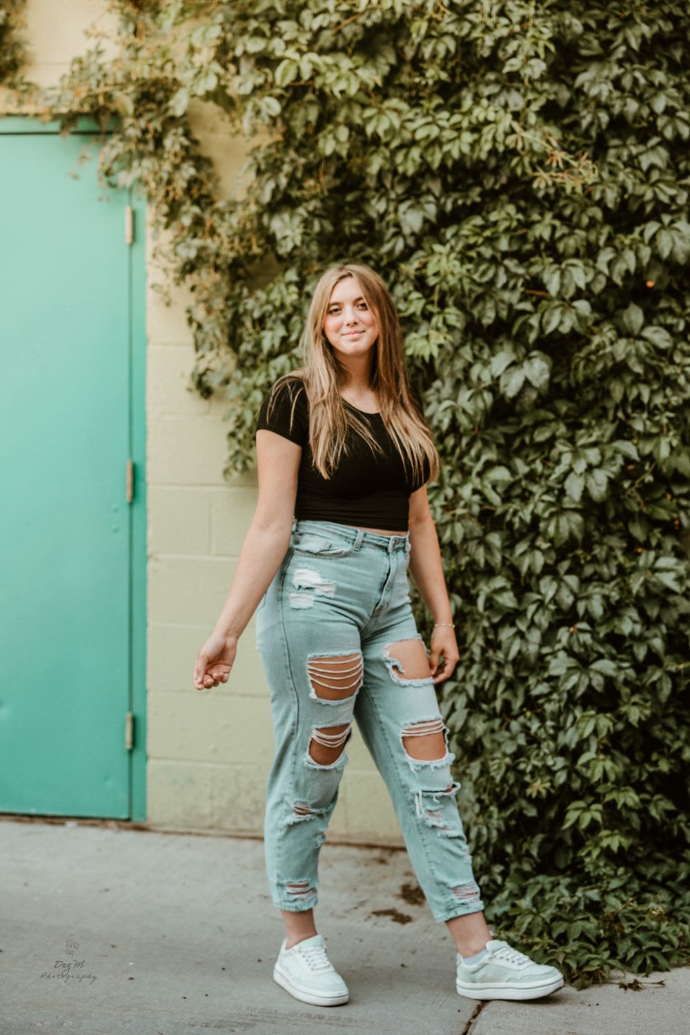 Casual fashion shots against green foliage and turquoise wall showing distressed denim style.