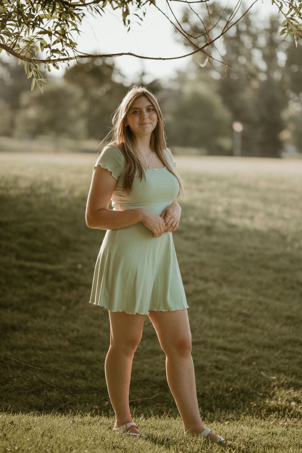 Sunset portrait session in a grassy field wearing mint green summer dress.