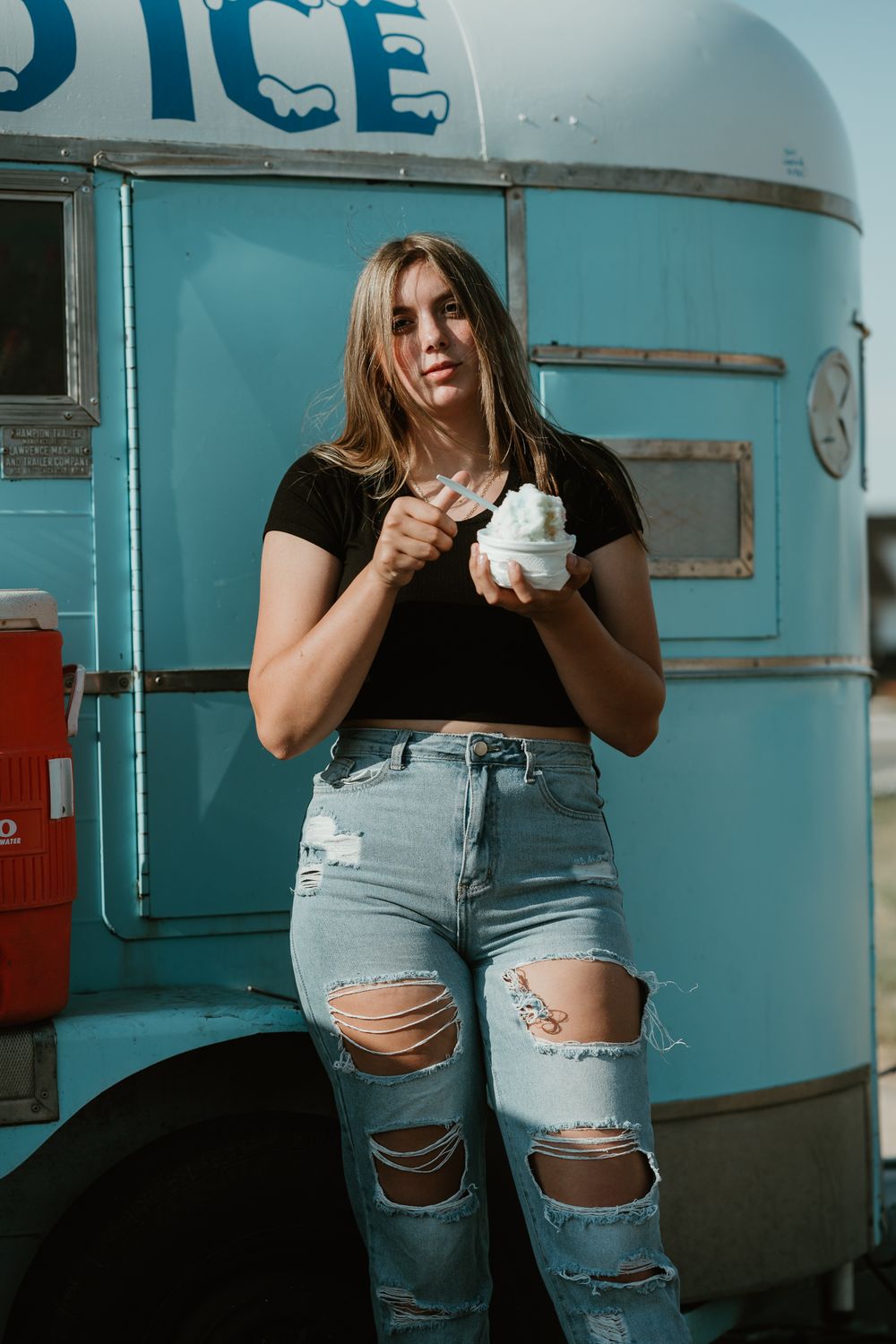 Lifestyle portraits featuring distressed denim against bright blue vintage truck exterior.
