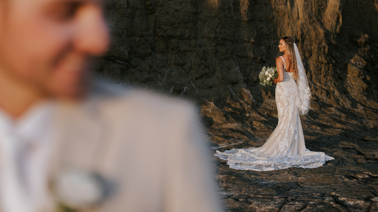 Romantic bride and groom portrait with rocks background at golden hour. in Punta Pita