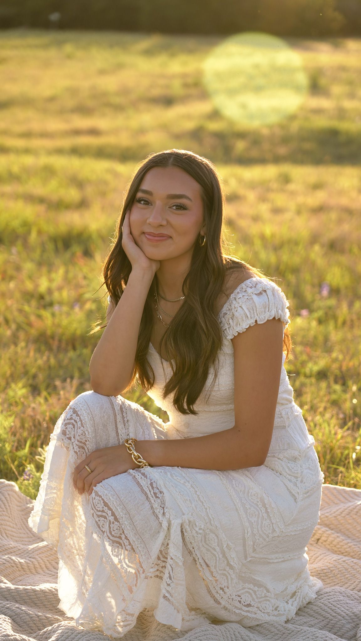 A joyful portrait outdoors with autumn trees and golden sunlight in the background.