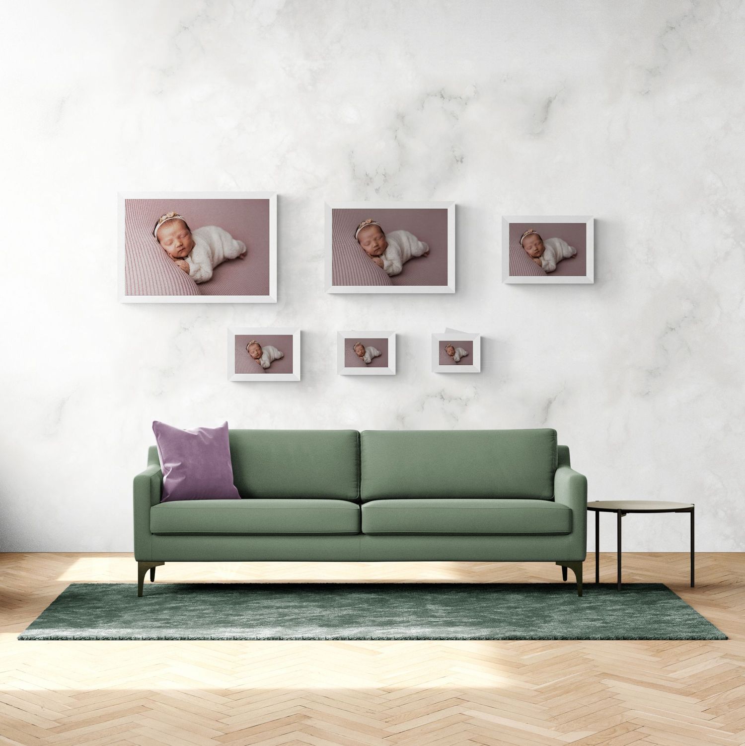 A cozy green couch with three framed pictures hanging on the wall above it.