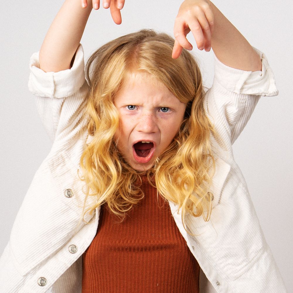 Blonde little girl making silly face for portrait session taken by Dandridge Tennessee children's photographer