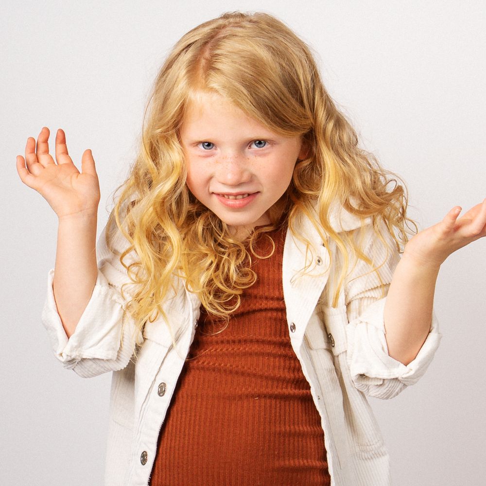 Blonde little girl making silly face for portrait session taken by Dandridge Tennessee children's photographer
