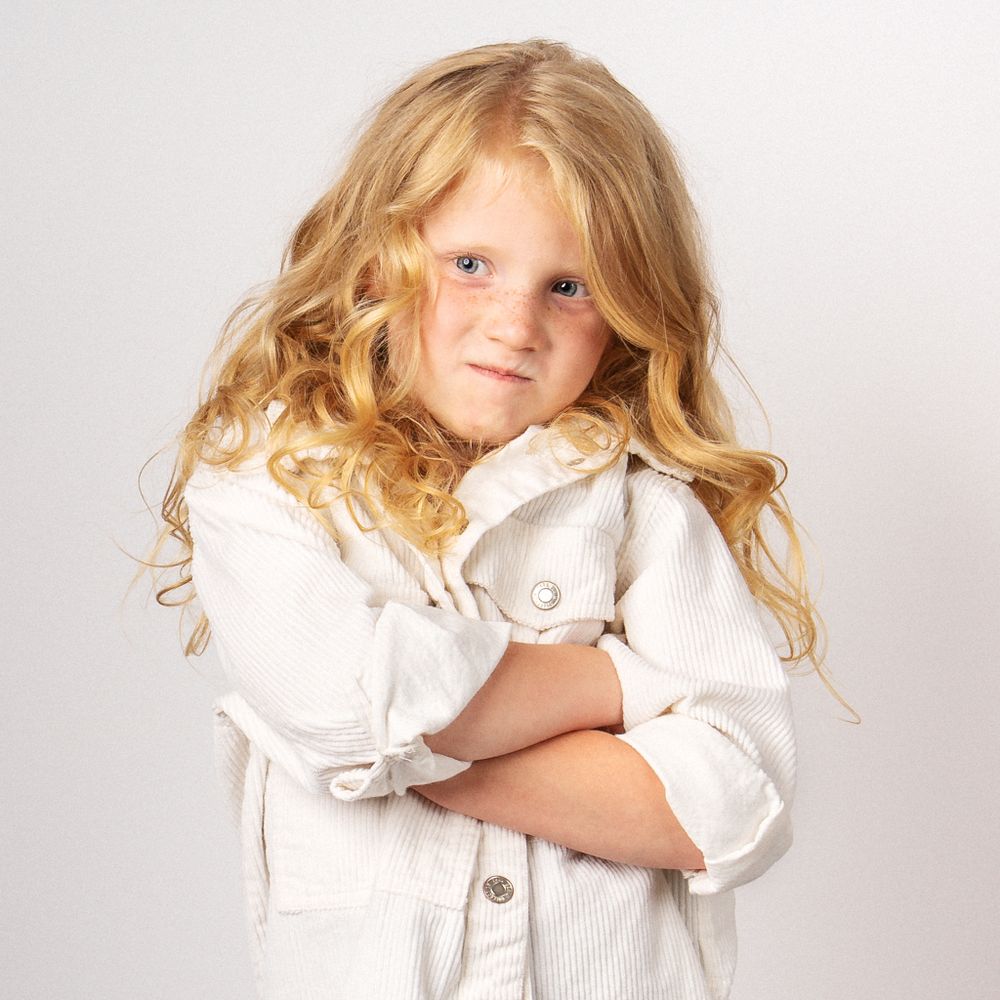 Blonde little girl making silly face for portrait session taken by Dandridge Tennessee children's photographer