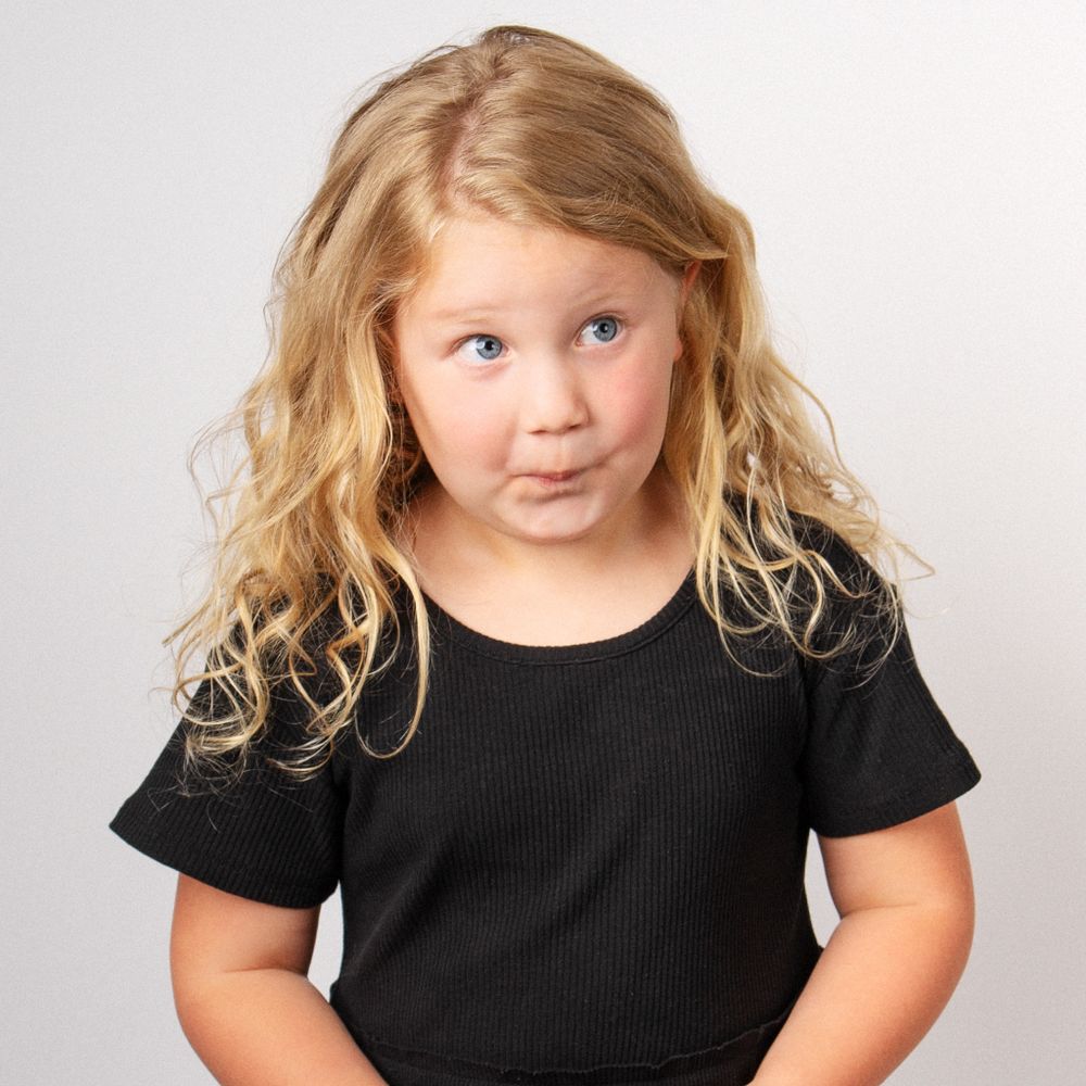 Blonde little girl making silly face for portrait session taken by East Tennessee children's photographer