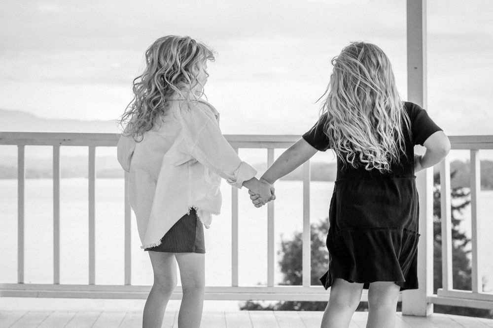 Black and White photo of little girls holding hands on gazebo by Douglas Lake taken by Dandridge Tennessee photographer