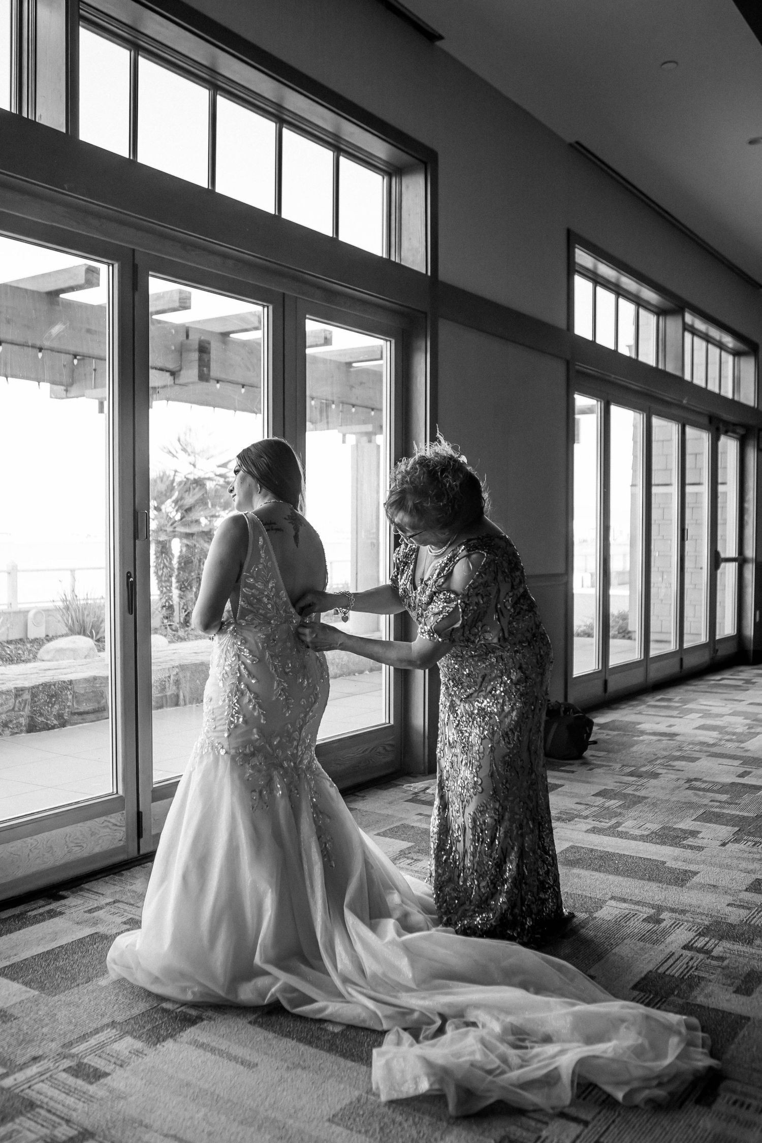 Black and white photos of wedding dress preparation in sunlit room.