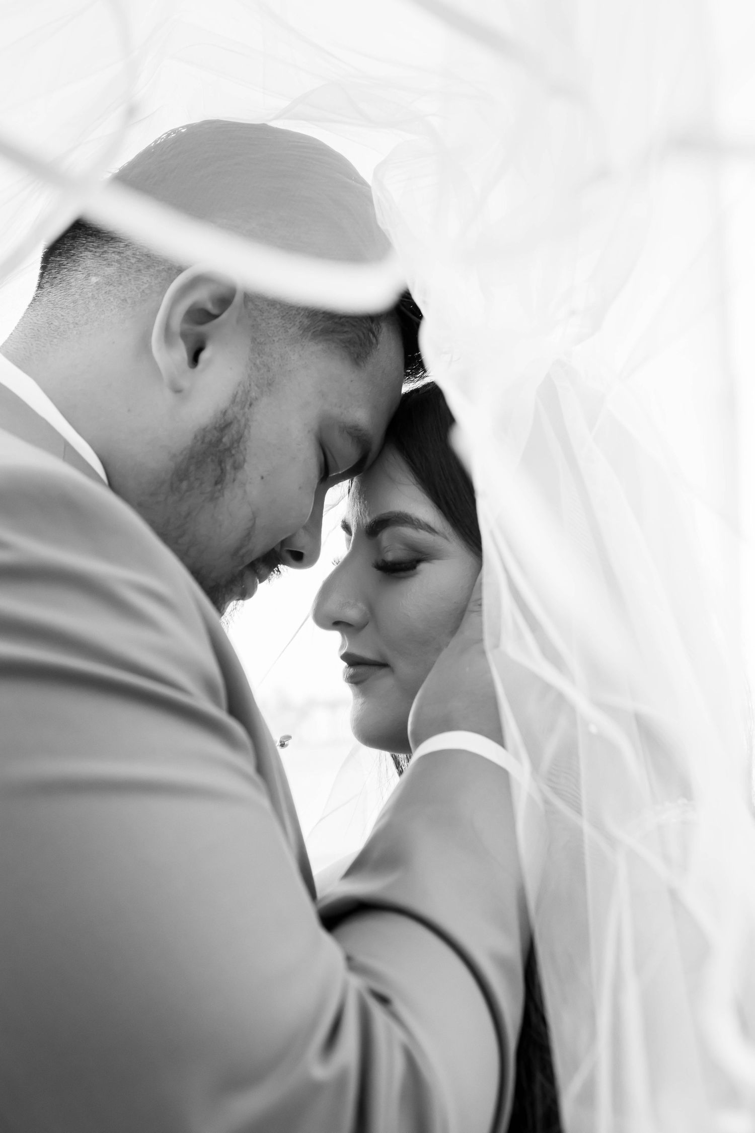 Black and white romantic close-up wedding portraits showing tender moments between newlyweds.