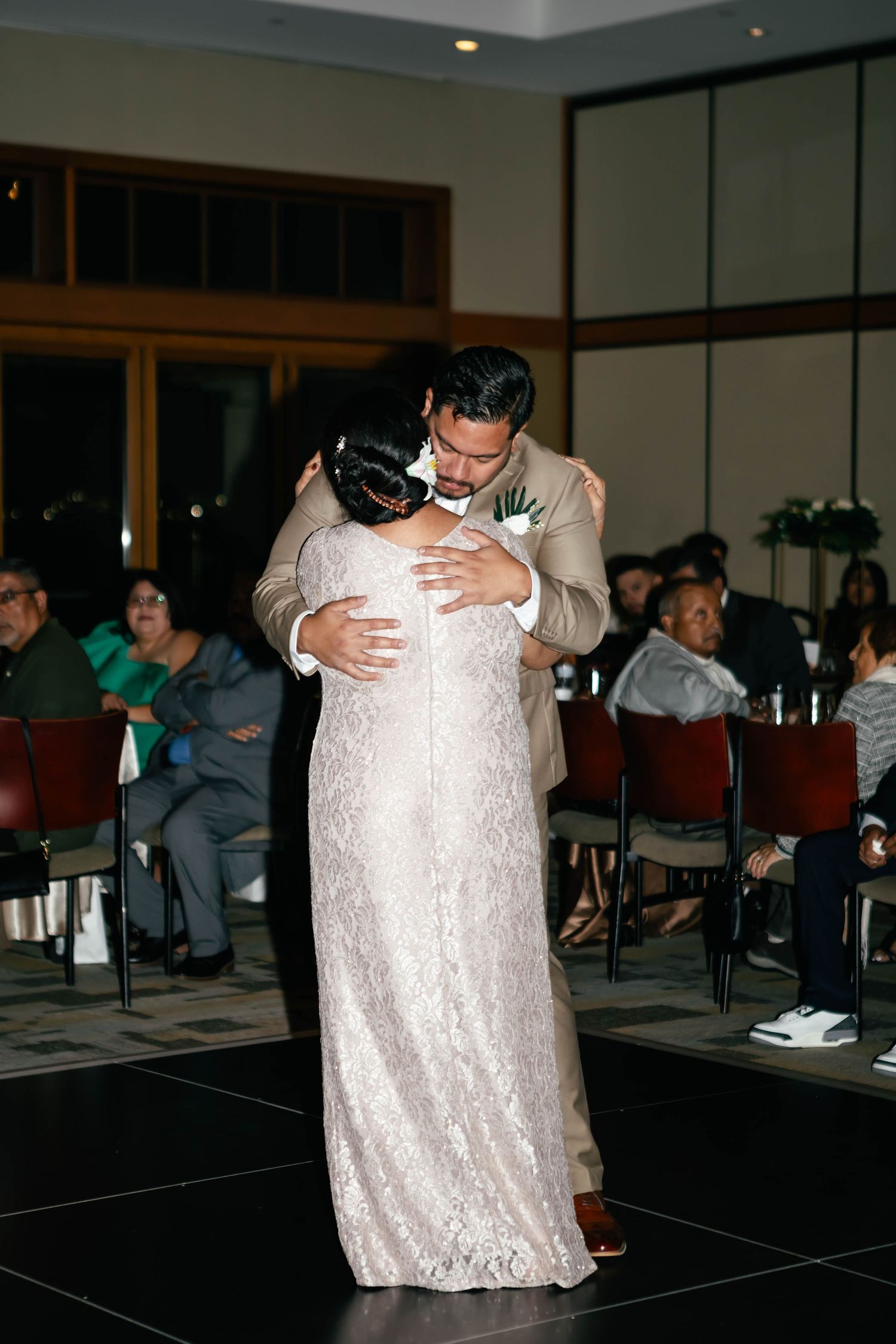 Wedding reception dance floor with couples embracing during slow dance.