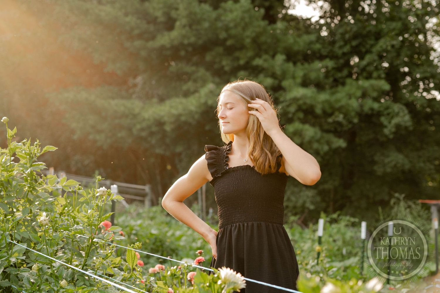 A candid moment captured in a flower garden during golden hour lighting.
