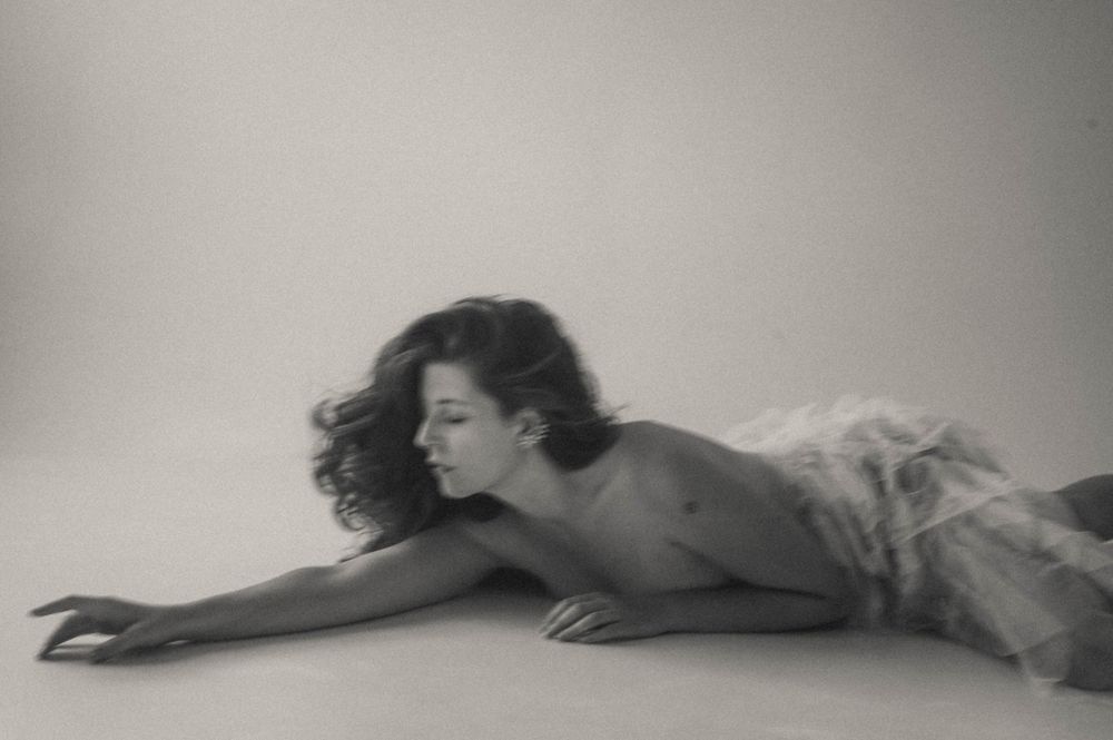 Black and white artistic nude photography sequence showing reclining poses.
