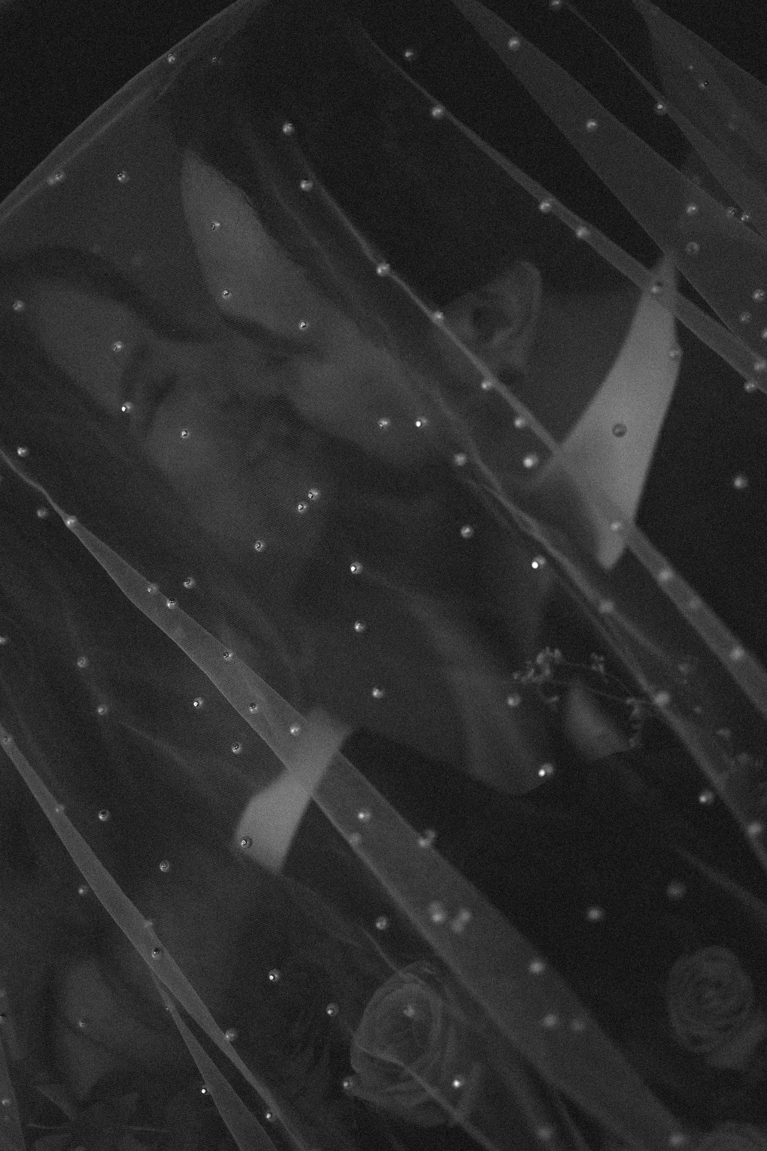 Abstract black and white photograph with diagonal lines and scattered points of light creating a moody atmosphere.