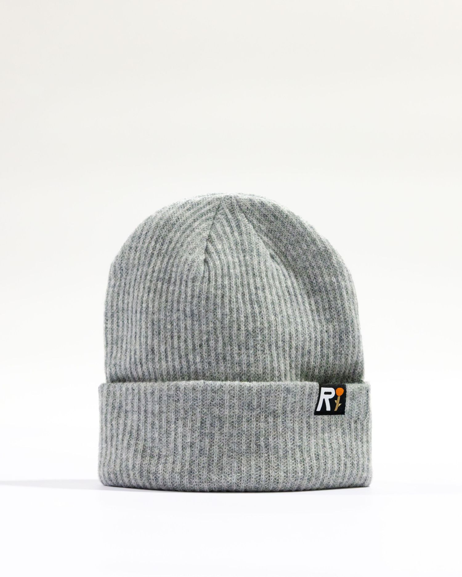 A gray ribbed knit beanie with a small R logo patch displayed against a plain white background.