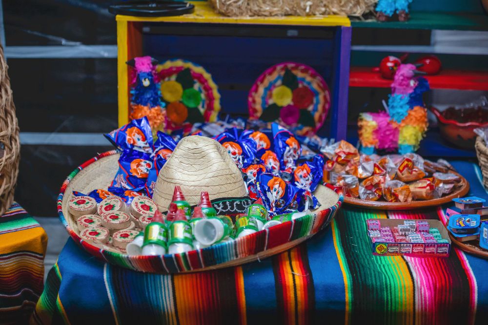 Colorful Mexican sombreros lined up on display at an event.