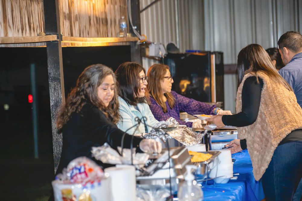 Guests seated at dining tables during an evening celebration.