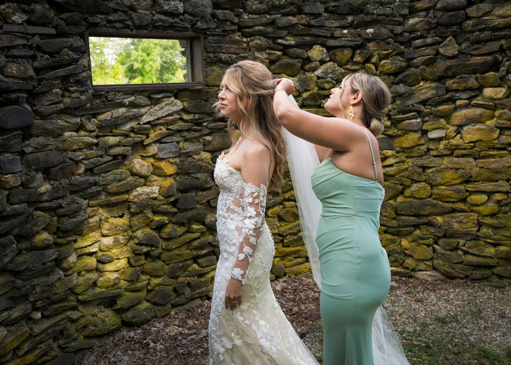 A series of photos showing moments during a wedding near a rustic stone wall with bridesmaids in mint green dresses.