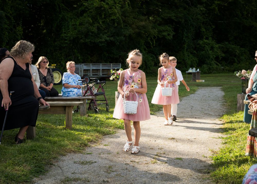 People enjoying a sunny summer day at a park or recreational area near a lake.
