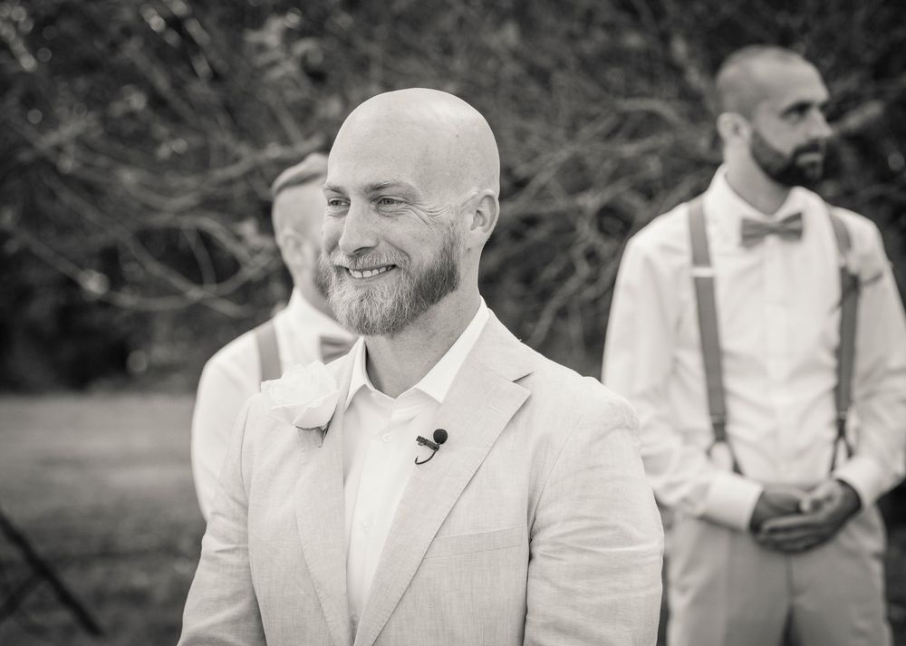 A collage of black and white wedding photos showing candid moments and expressions during an outdoor celebration.