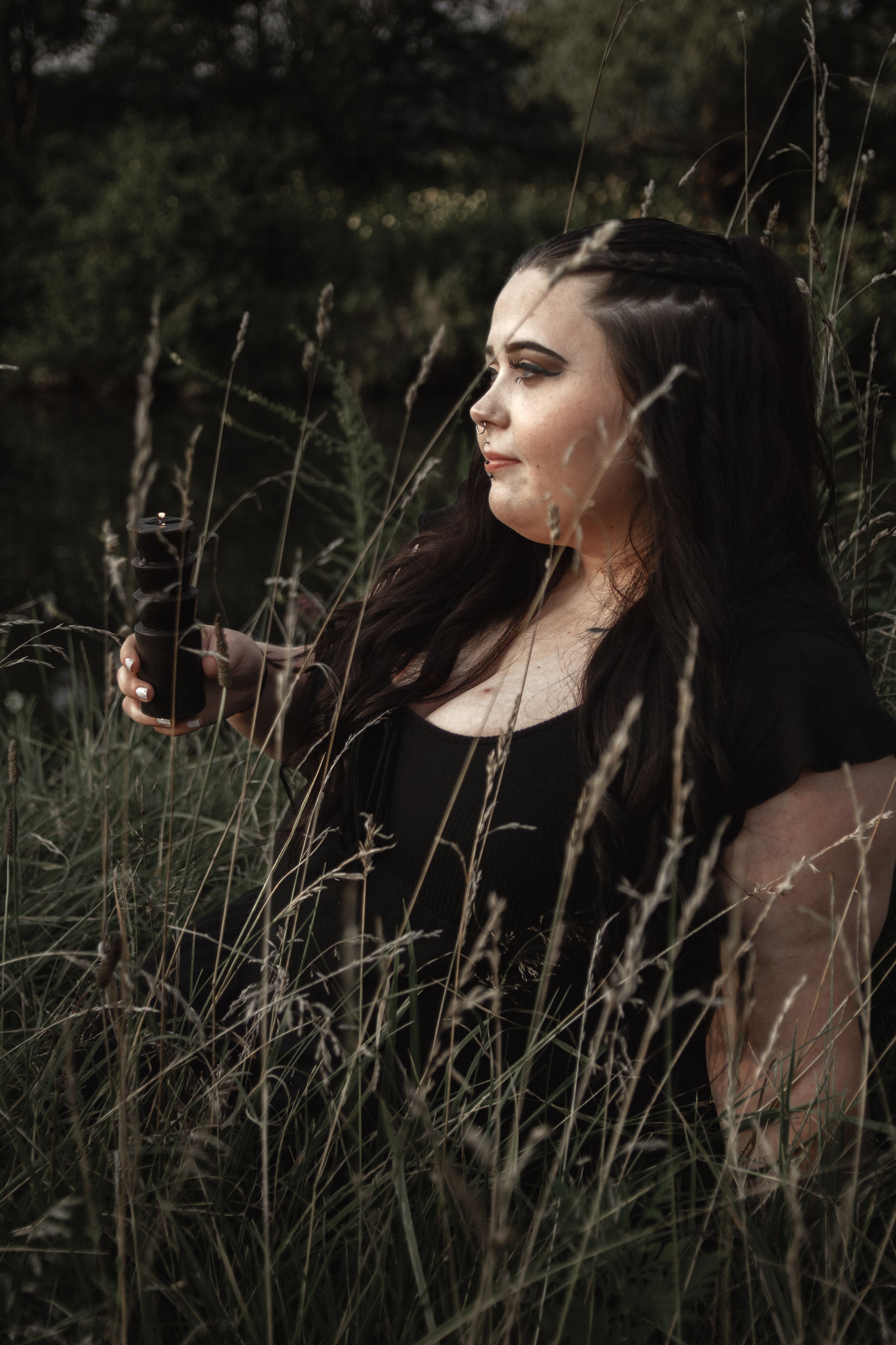 A moody portrait series showing a figure in dark clothing among tall grass and shadows in a natural outdoor setting.
