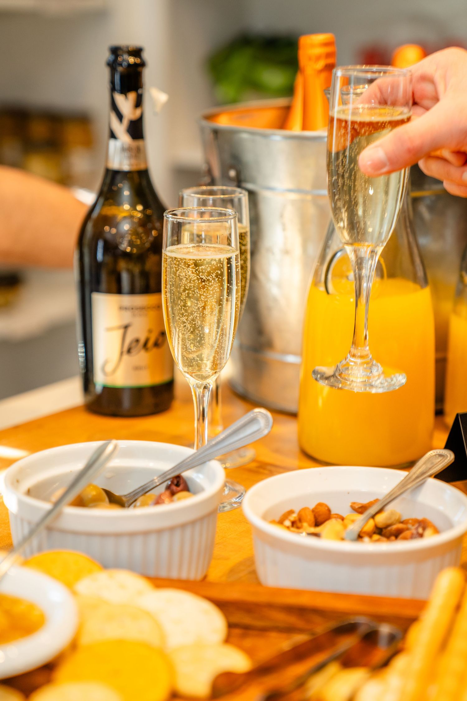 A series of dining table shots showing champagne glasses, plates, and food service during a meal or celebration.
