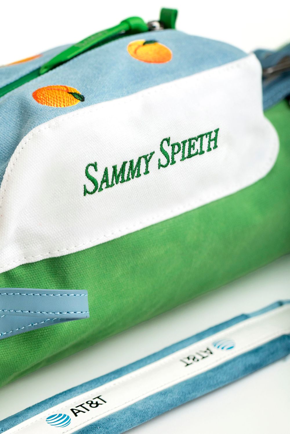 Sammy Spieth branded golf bag in green and blue with peach embroidery and AT&T sponsor logo detail.
