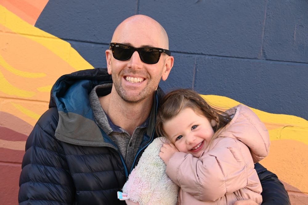 A heartwarming series of photos showing a parent and child bonding against a colorful wall backdrop.
