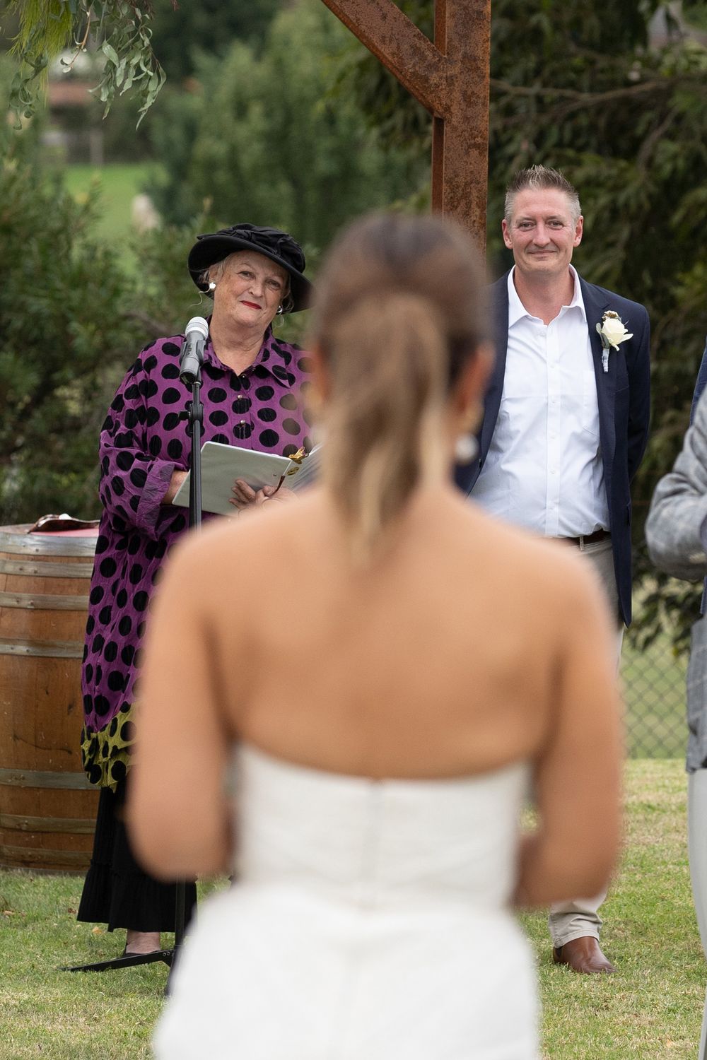 A sequence of candid outdoor wedding photographs showing joyful interactions between wedding guests in an outdoor garden setting.