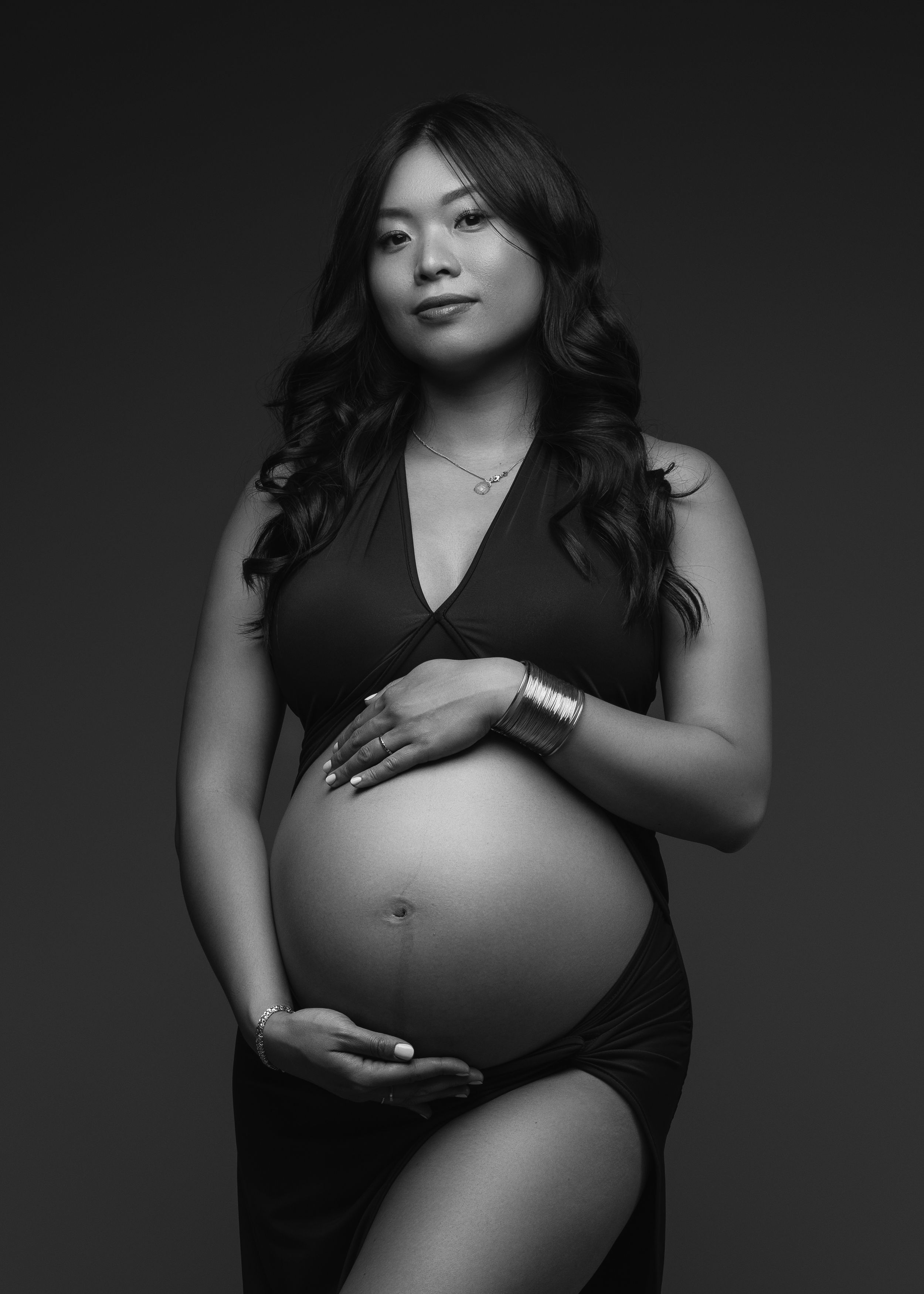 Black and white maternity photography sequence showing silhouetted figure in progressive stages of pregnancy.
