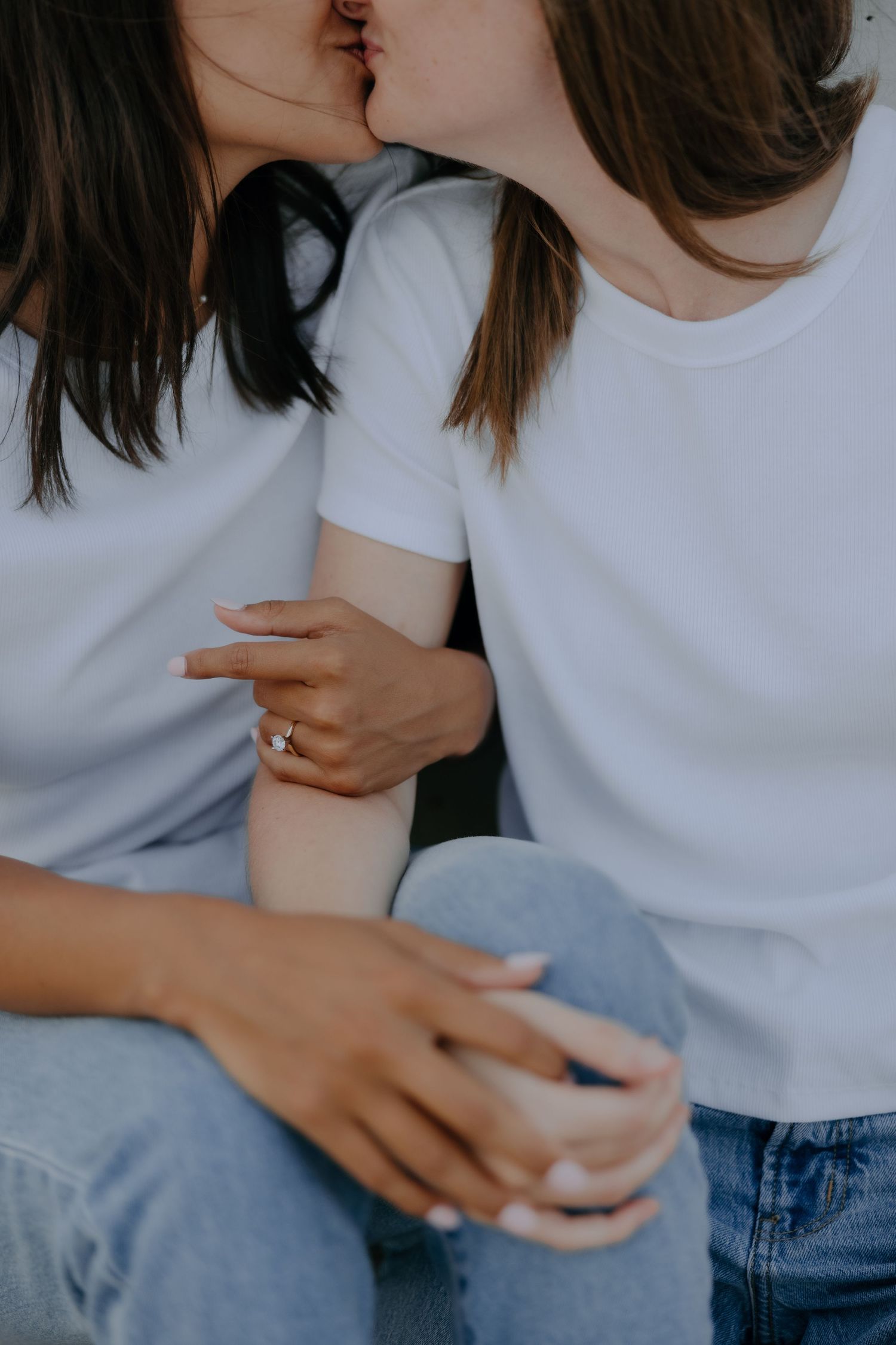 Close-up of LGBTQ+ couple holding hands — soft romantic tones by inclusive wedding photographer.