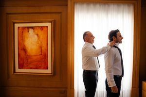 A series of connected photos showing a couple moving through a romantic dance sequence in an elegantly lit interior space.